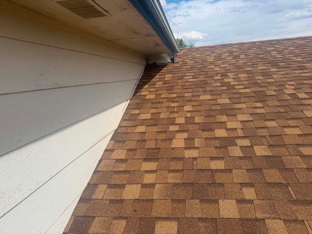 New shingles meeting siding with clean flashing detail