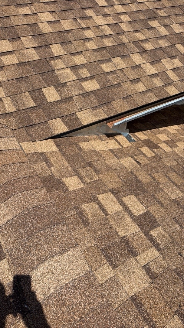 New shingles and reset drip edge along a roof-to-roof transition