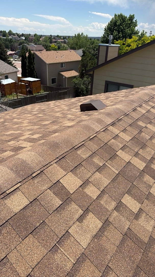 Clean hip and ridge shingle lines on a finished roof replacement in Security-Widefield, CO
