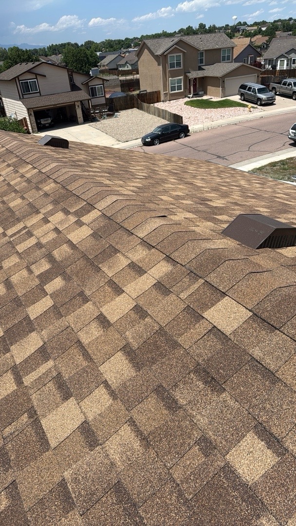 Newly installed architectural shingles on a Security-Widefield, CO home with slope-mounted attic vent