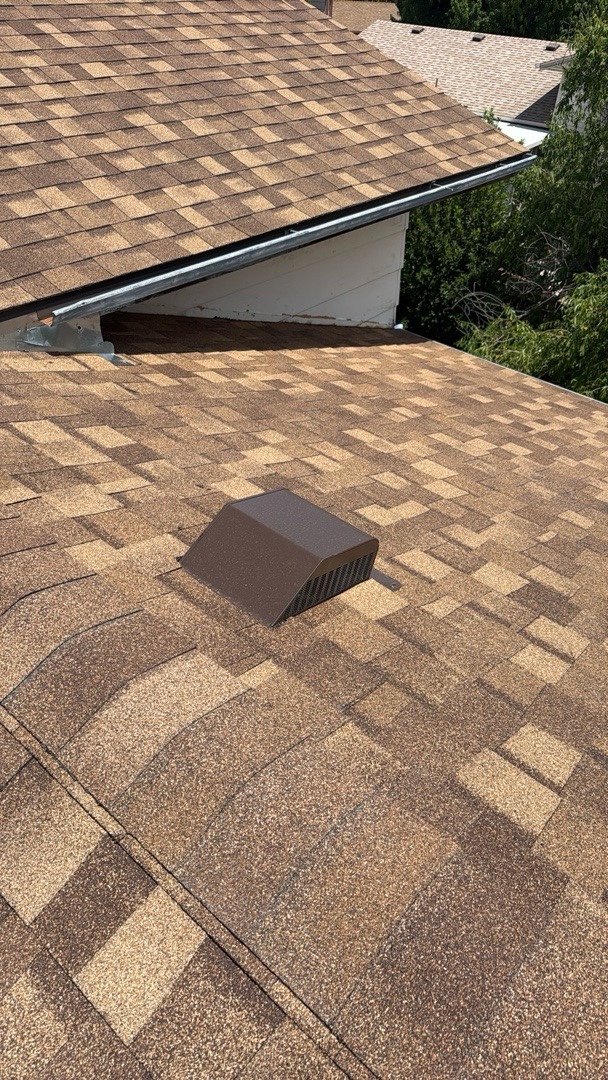 Replacement attic vent set into freshly installed shingles