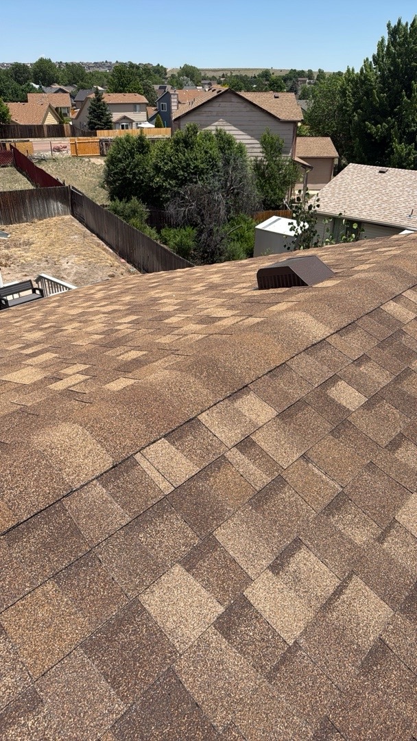 Completed shingle roof ridge and vent on a home in Security-Widefield, Colorado