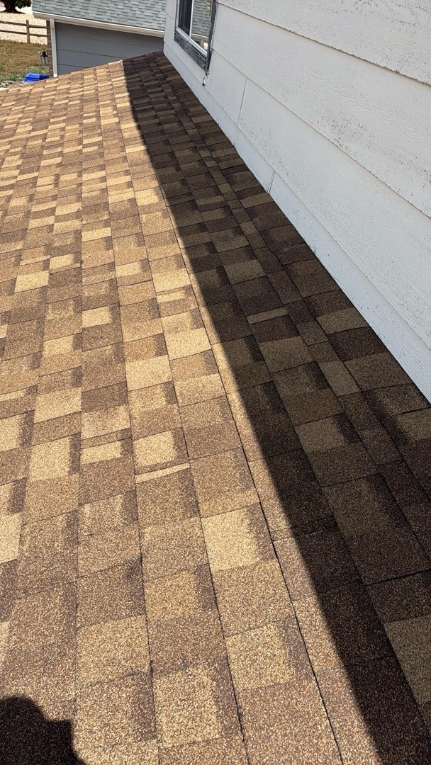 Close-up of new shingle courses running along the sidewall of a Security-Widefield roof
